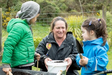Adult and children gardening. 