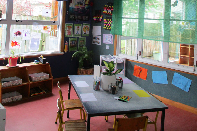 Corner of the kindergarten set up with a table and chairs, and resources to create things out of paper